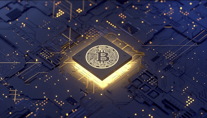 Crypto 101: The Basics of Cryptocurrency Graphic of a motherboard with a square that is illuminated with light, in the center of that is a bitcoin logo