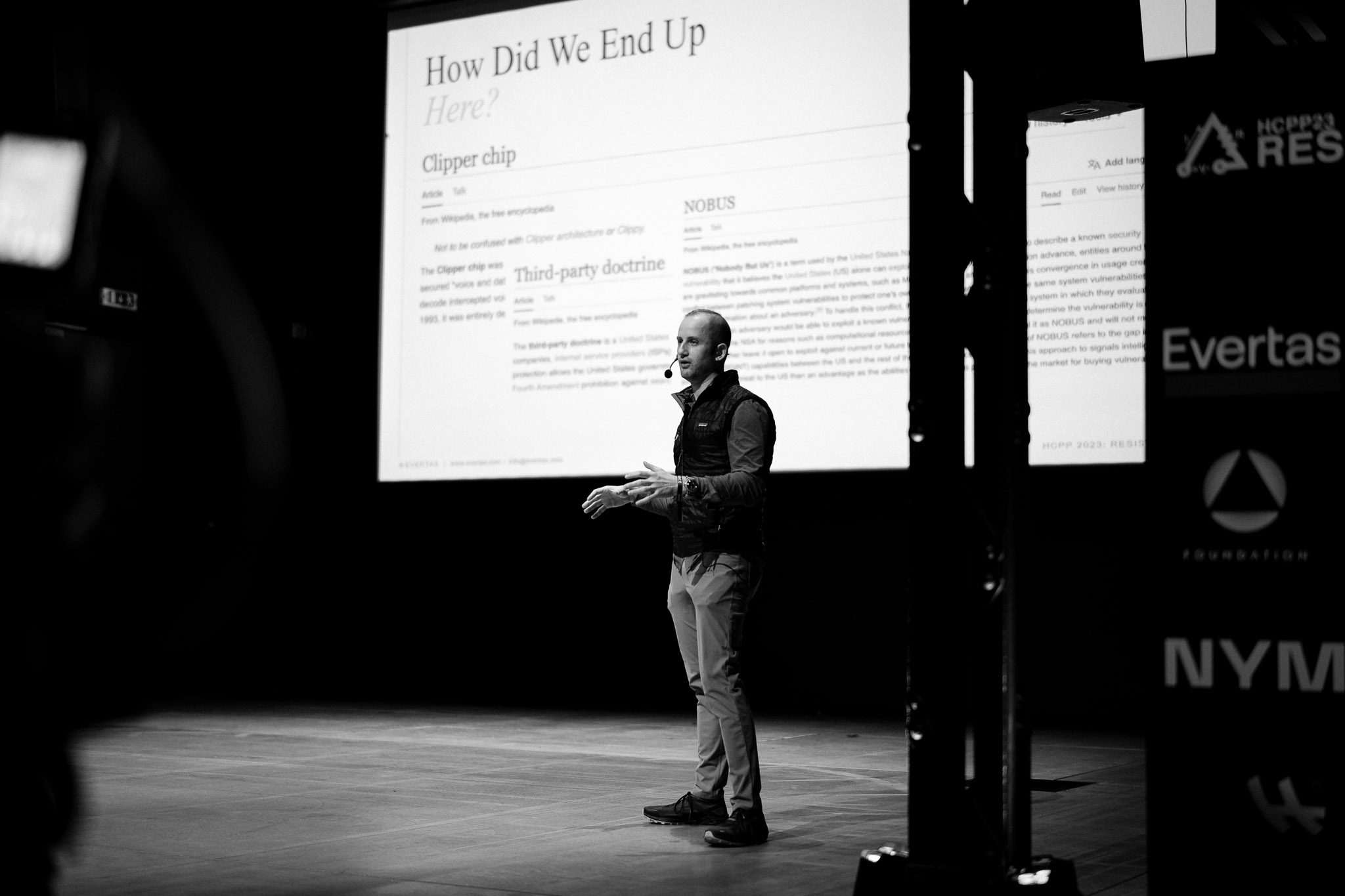 Video: How Financial Regulation Erodes Privacy Man speaking at seminar with projector screen behind him. The projector shows text that reds 'How Did We End Up Here?'